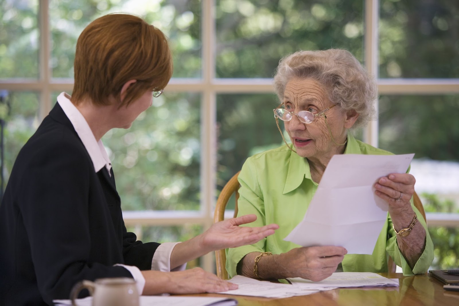 A senior discusses her future financial plans with a financial planner.