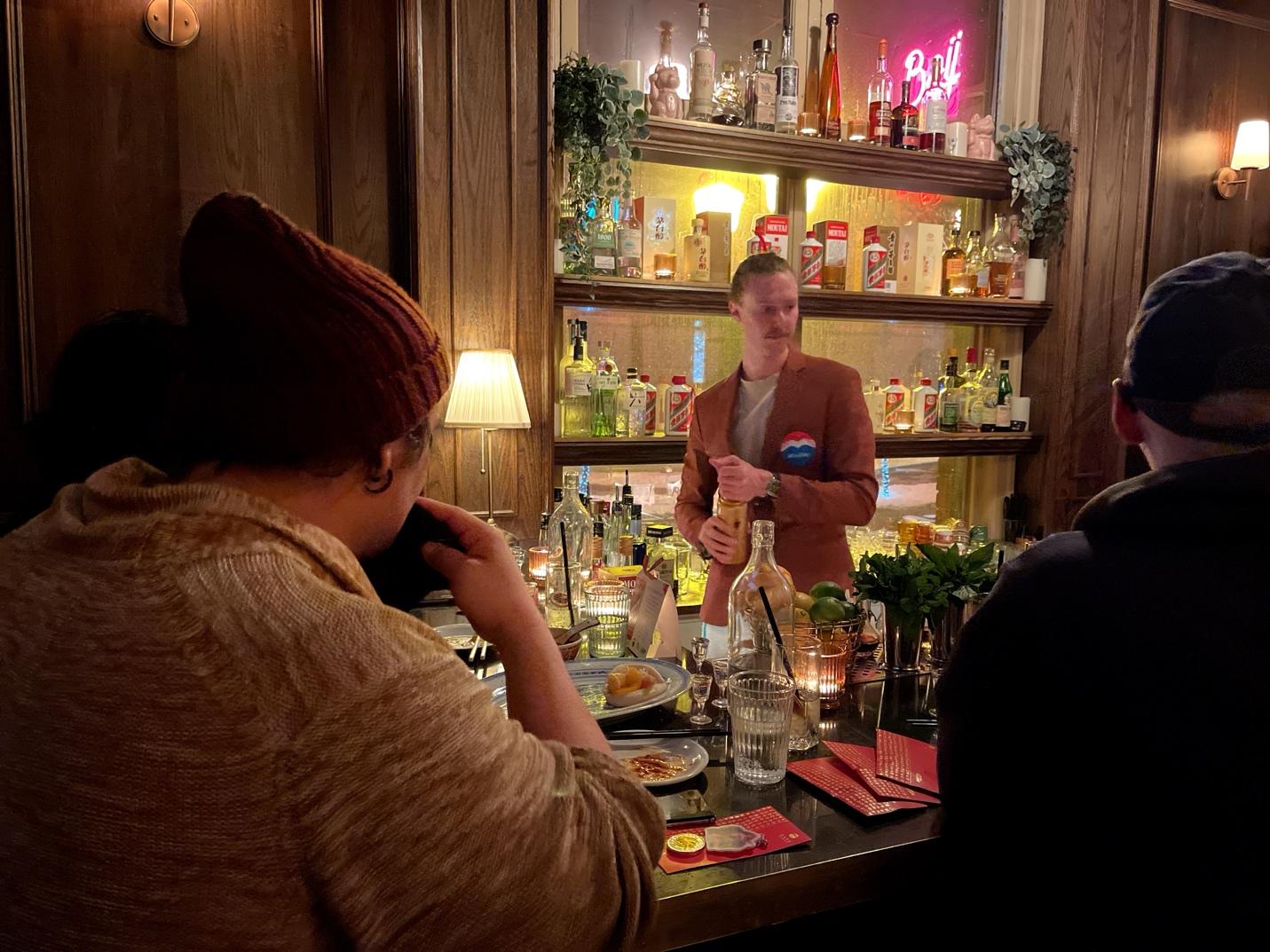 A group of people sitting at a bar

AI-generated content may be incorrect.