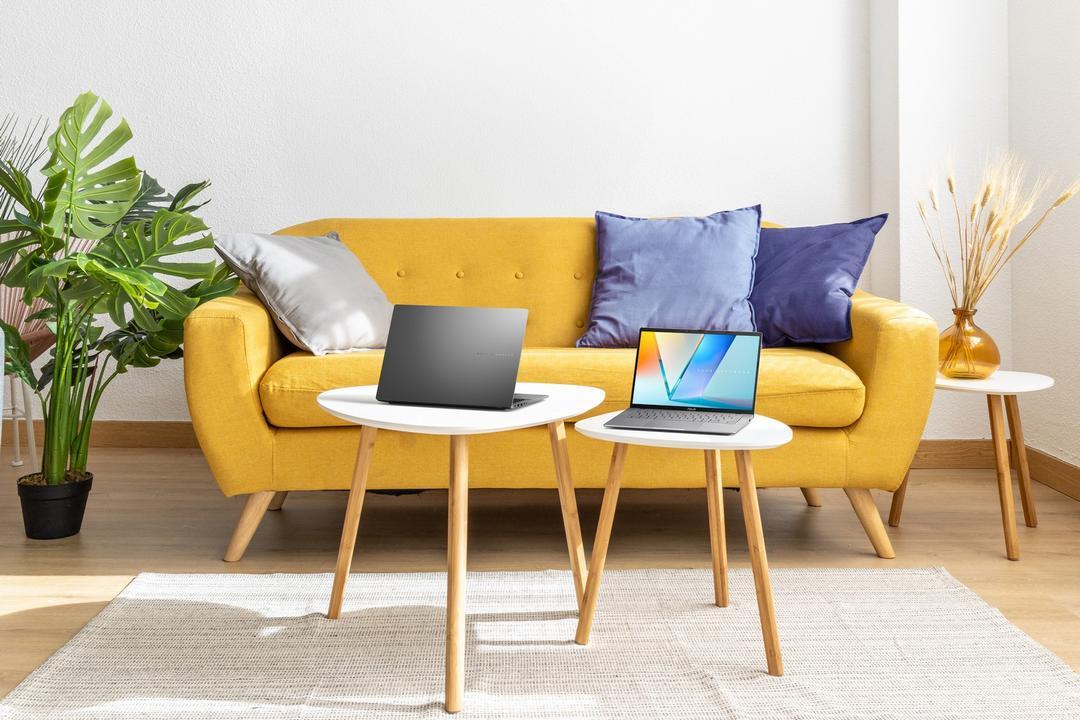 A yellow couch with two laptops on tables

AI-generated content may be incorrect.