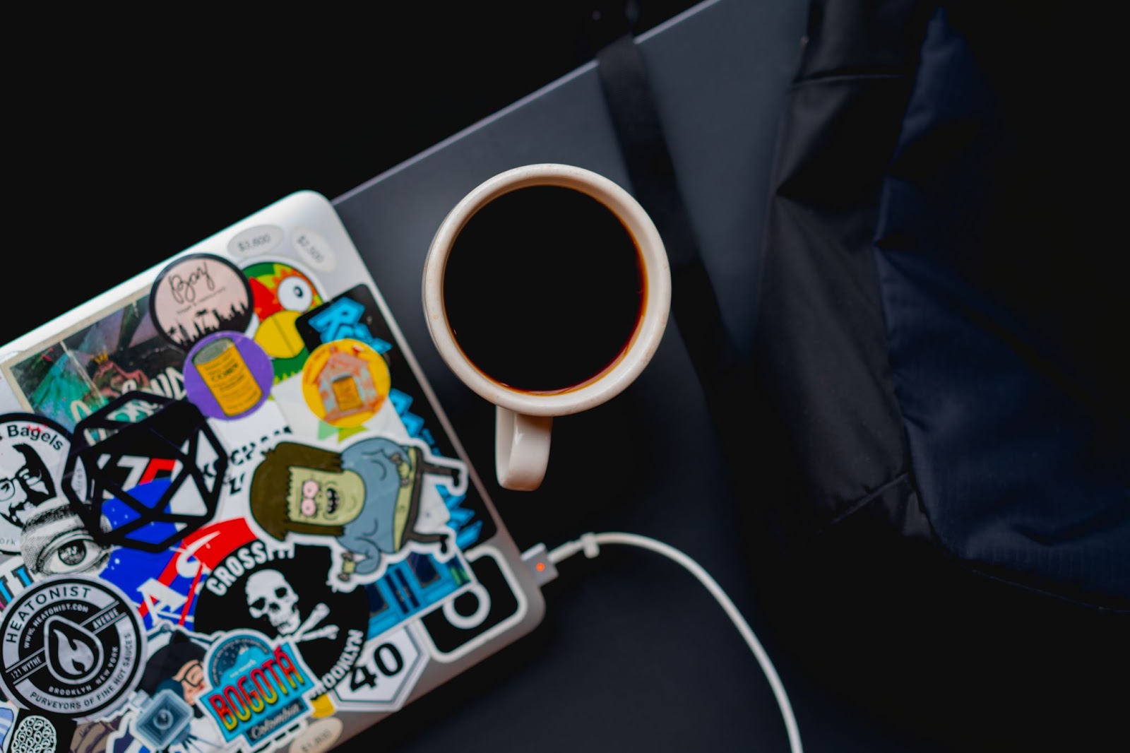 Laptop and coffee mug resting on a side table on a Japanese train 