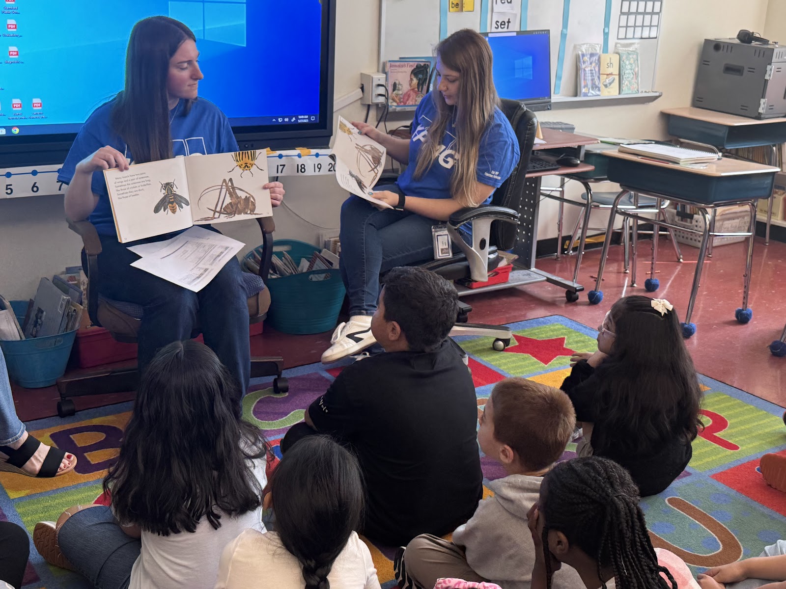 KPMG volunteers reading to Hart students