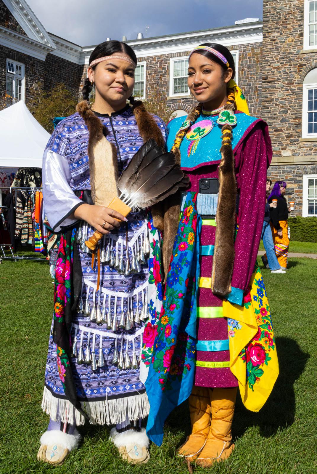 Two girls wearing traditional clothing

Description automatically generated