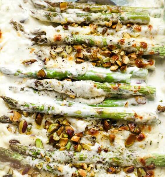 Asparagus with a creamy white sauce in a baking dish