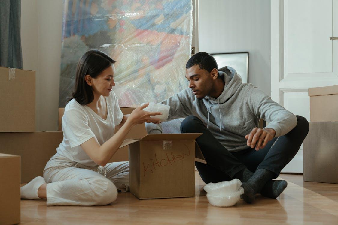 Free Man and Woman Sitting on Couch Stock Photo