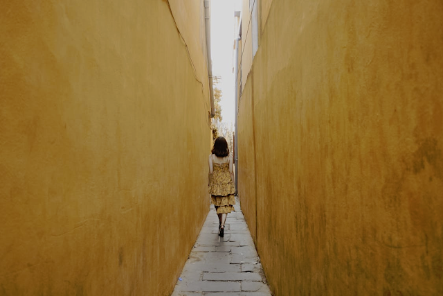 a woman walking though a street when she is traveling