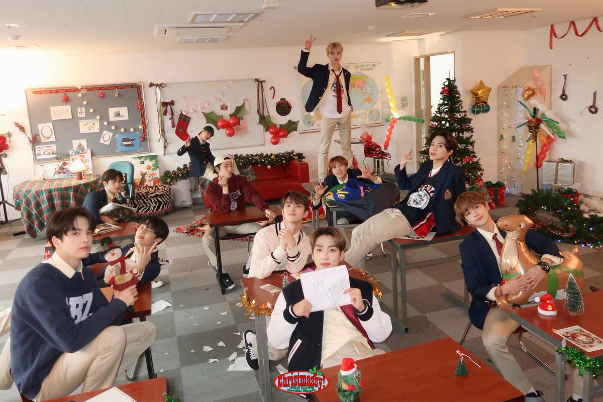 kpop group the boyz having a christmas party in a messy classroom