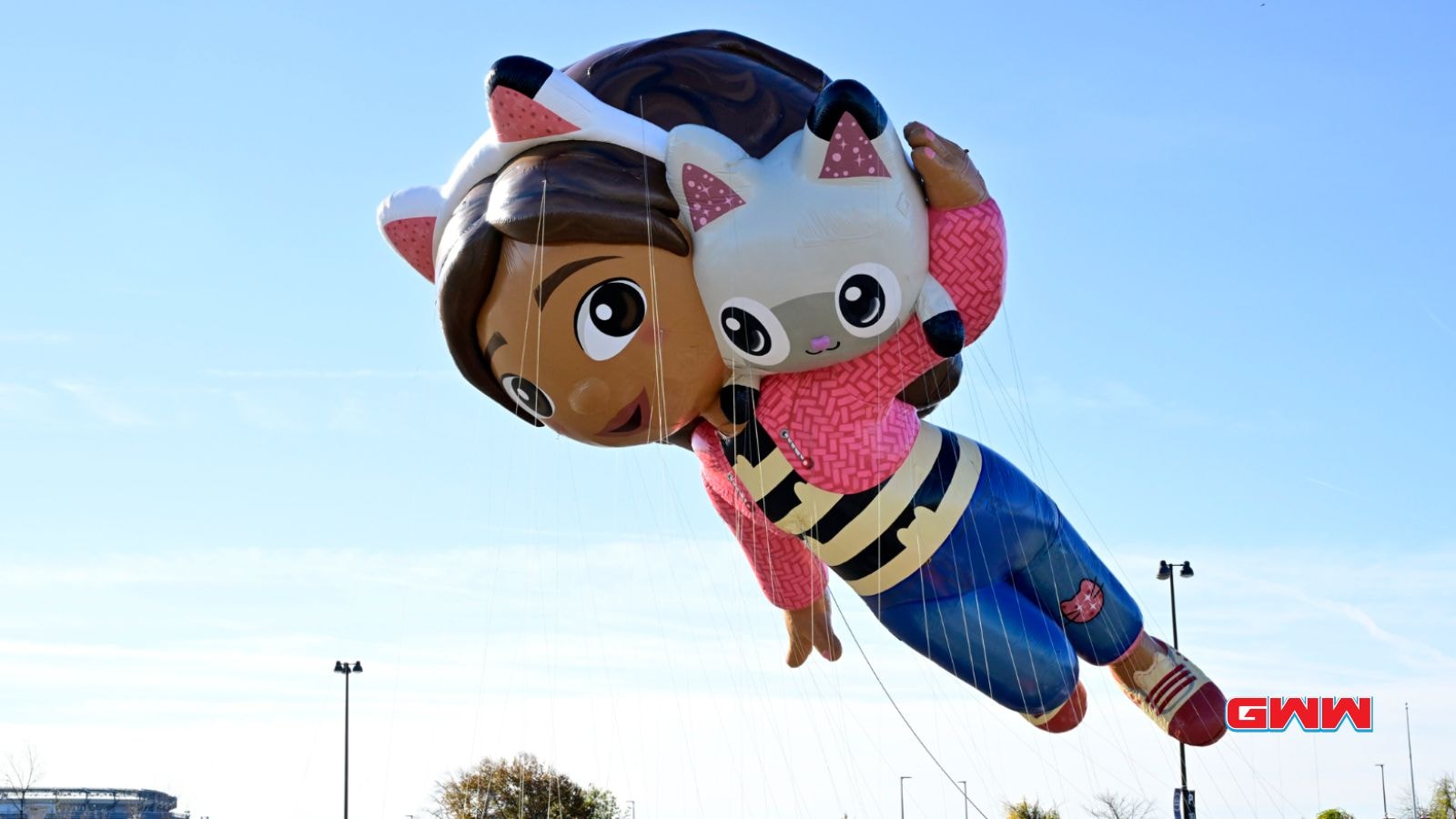 Colorful girl and cat balloon soaring in Macy's Thanksgiving parade.