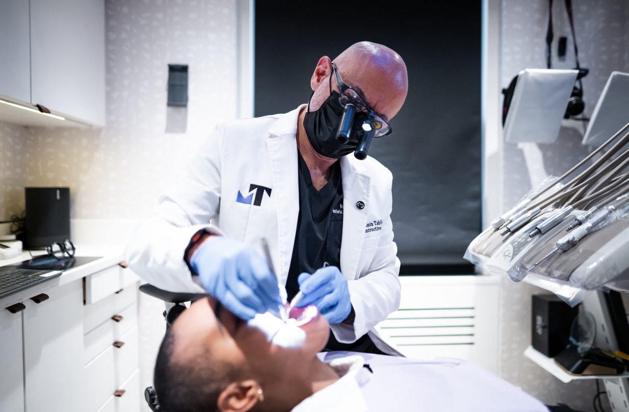 Dr. Tabib working with a patient