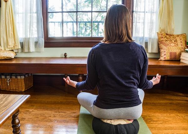 A person sitting on a mat in front of a window

AI-generated content may be incorrect.