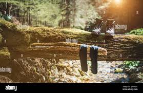 clothes and boots dried in the sun to keep them dry as one of the  top survival hacks for rainy weather camping