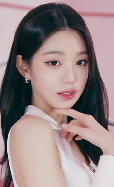 This contains an image of jang wonyoung ive putting on white dress  with his hand on her chin