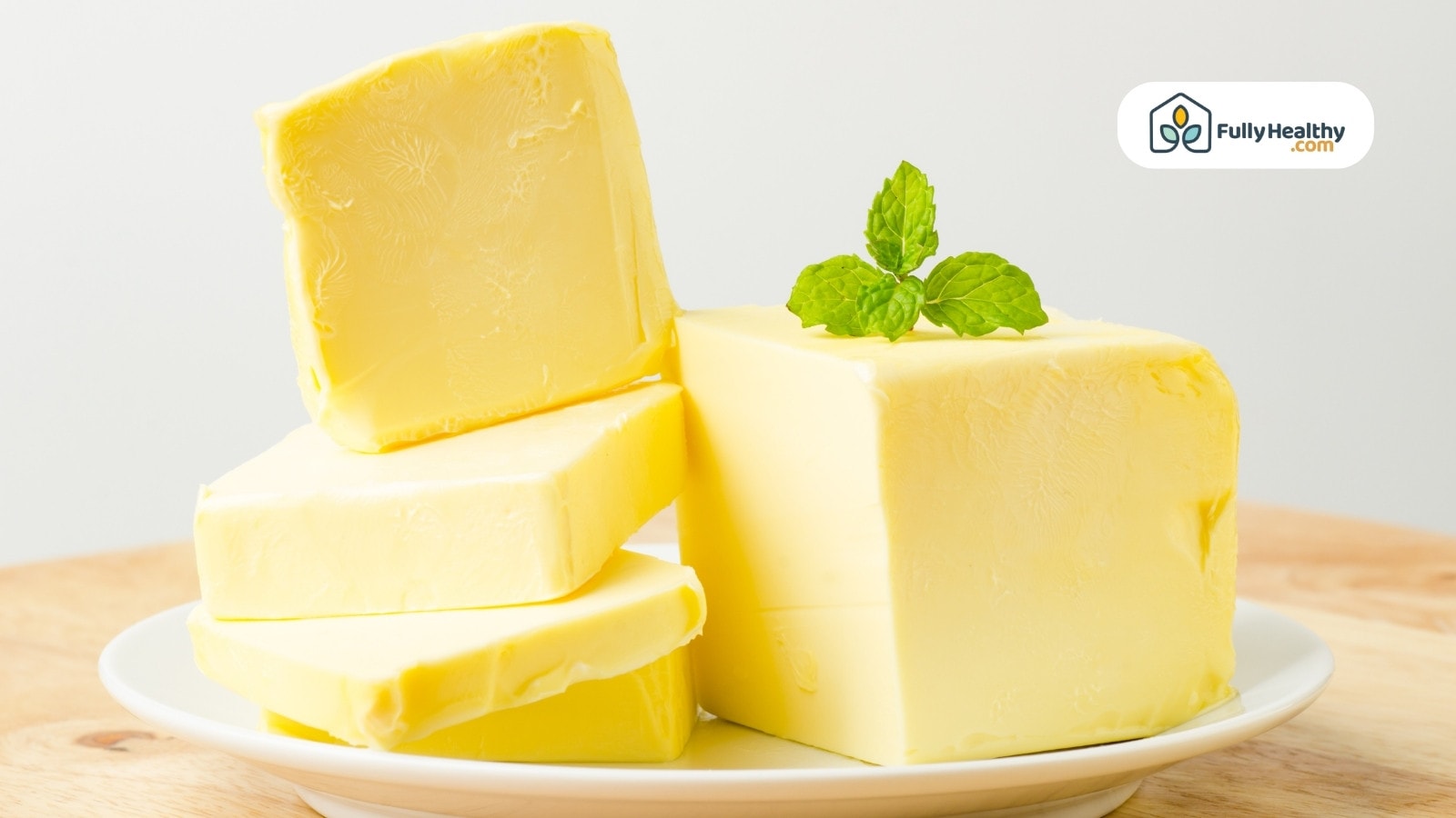 Stacked butter cubes on plate with fresh mint garnish