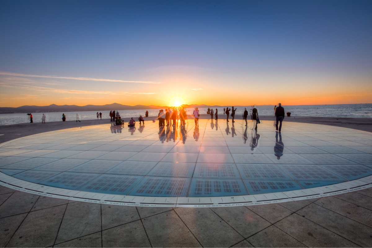 It's sunset time and and people enjoying the view
