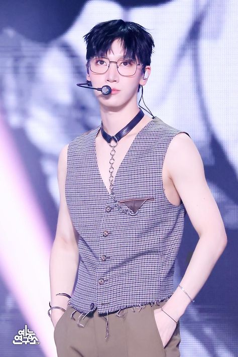 This contains an image of  NCT's Ten  wearing glasses and a tie with a nosepiece in his mouth is standing on a stage