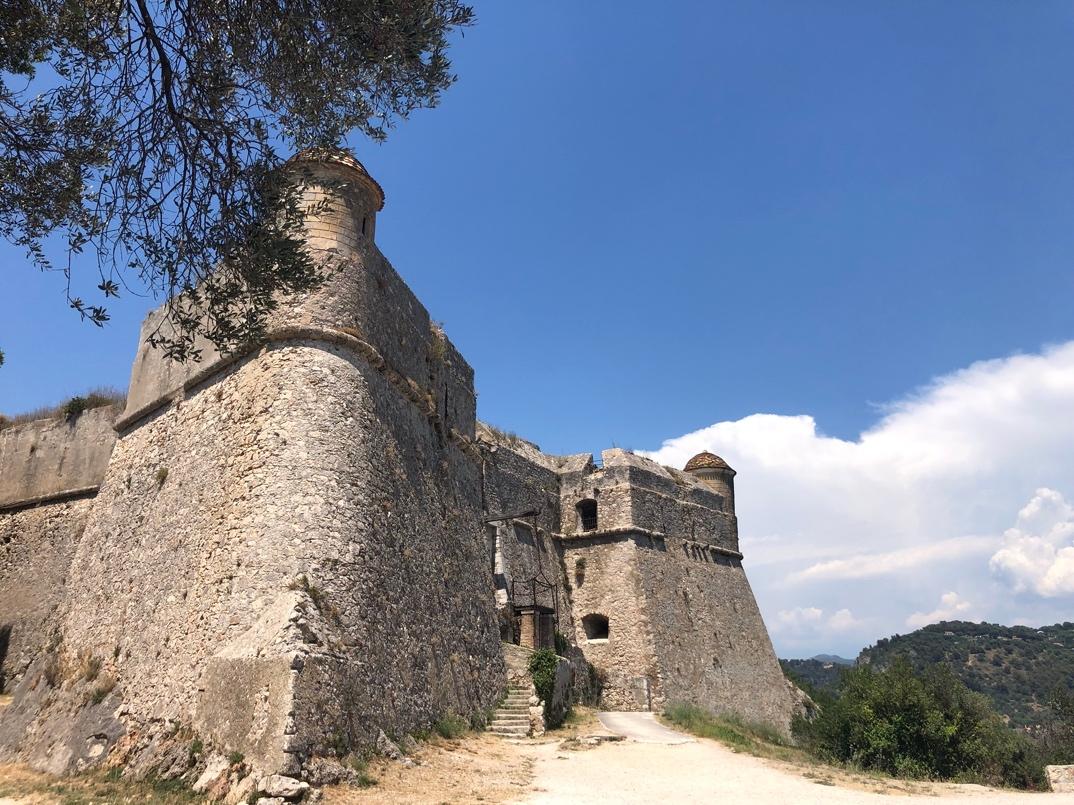 A stone castle with a tree in the background

Description automatically generated