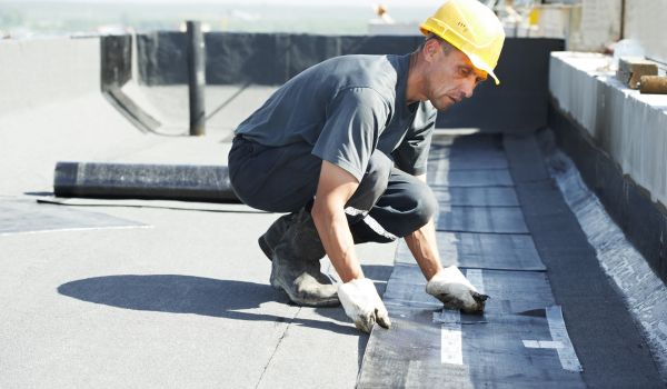 A Roofer working at TPO Roofing