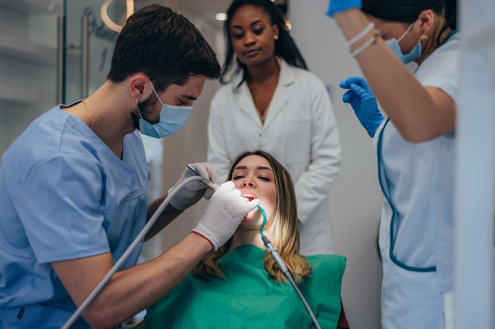 Surgeon performing tooth implant surgery for a patient that is an uncommon dental emergencies.