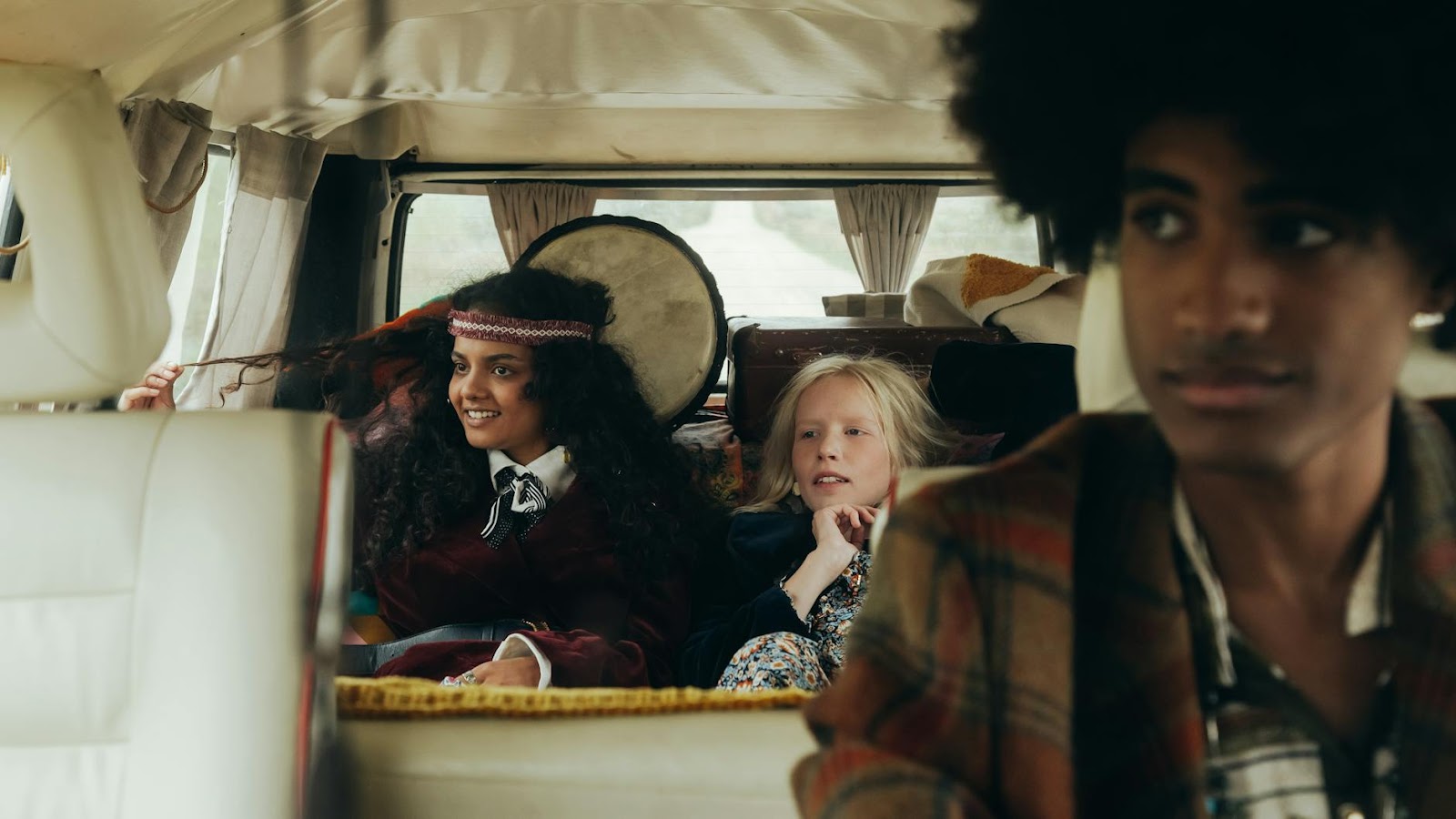 A diverse group of friends enjoying a road trip in a vintage van, embracing a retro lifestyle.
