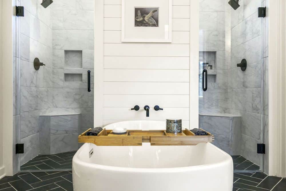 A closer look at the freestanding tub placed in front of the walk-in shower.