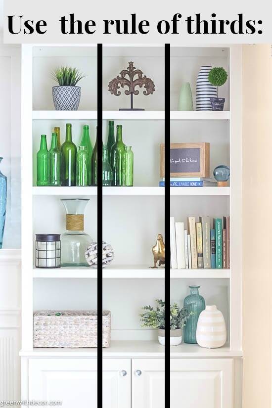 a white shelves with green bottles and vases