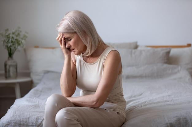 Aged woman feels unwell suffers from barometric pressure headache