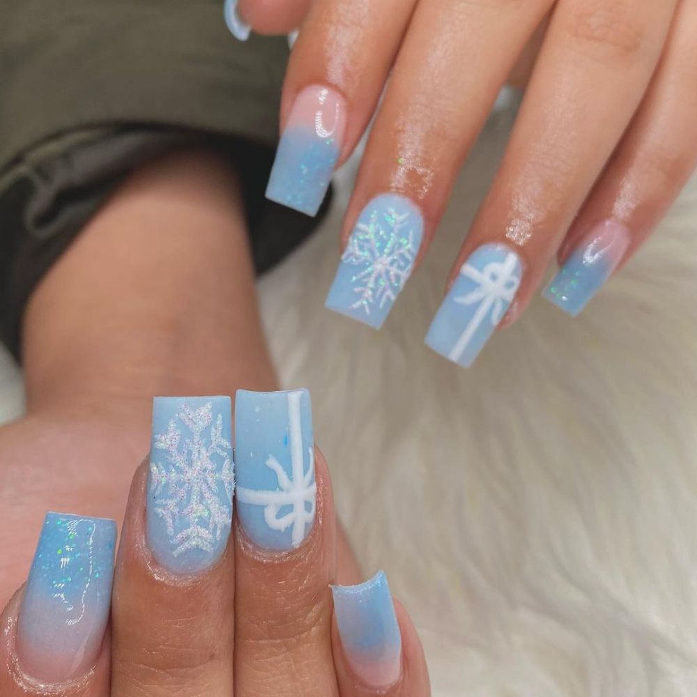 Close up of hands with blue winter nails having sky Blue Nails for winter