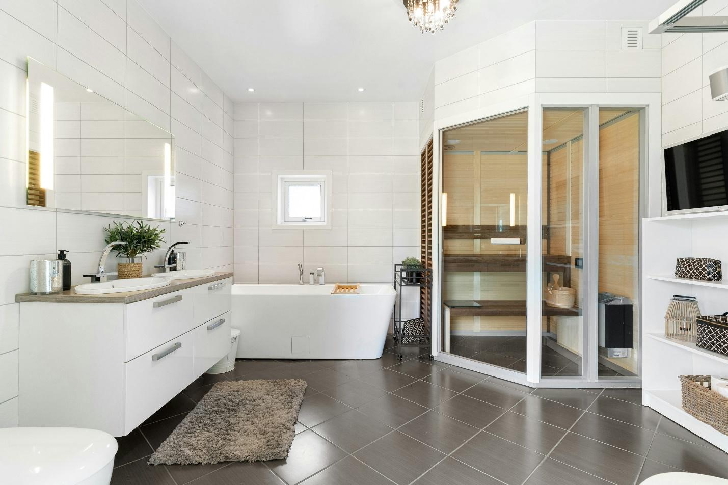 A bathroom with a tub, sink, mirror, and toilet