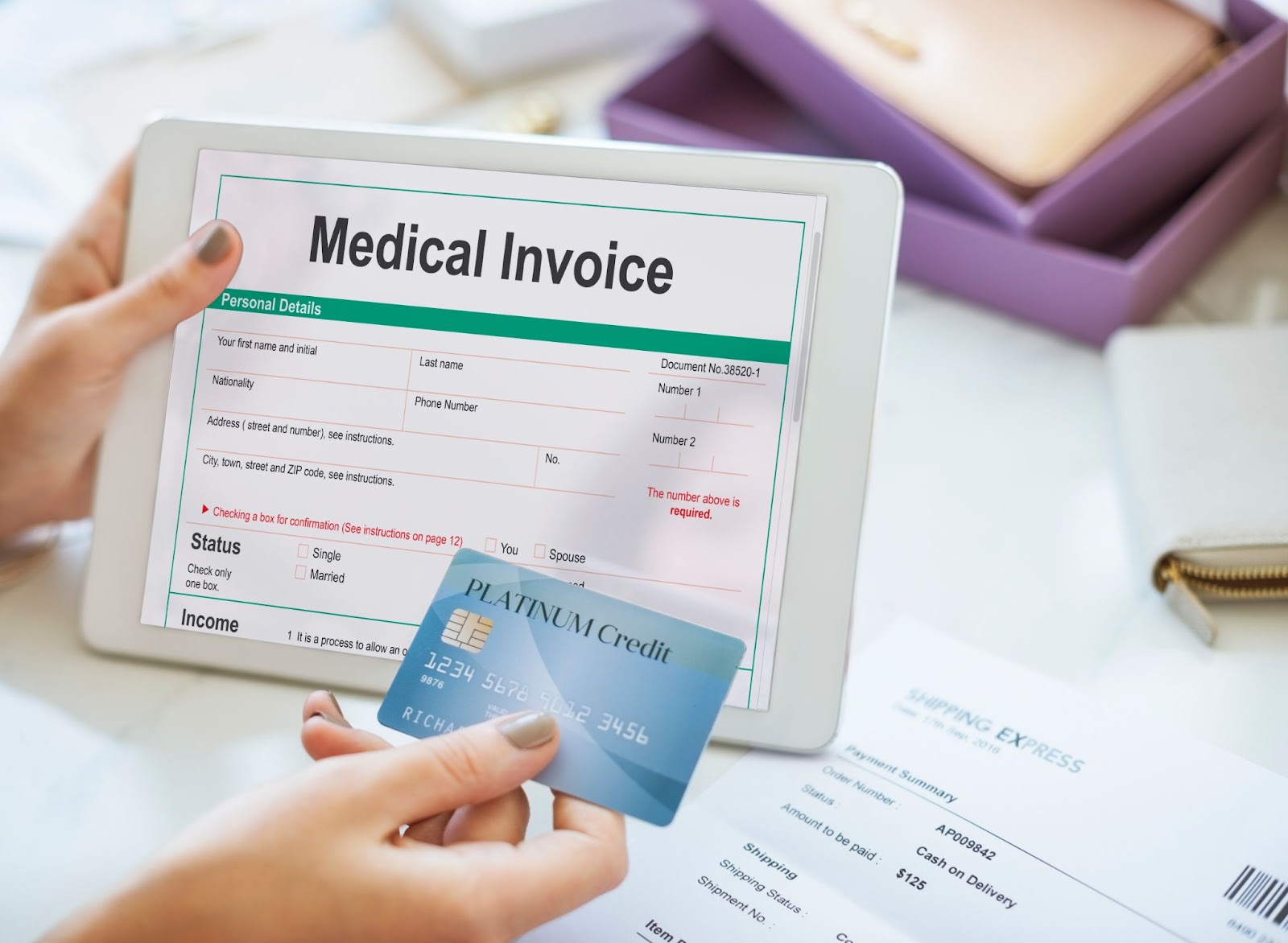 Person holding a tablet displaying a fake medical bill and a credit card