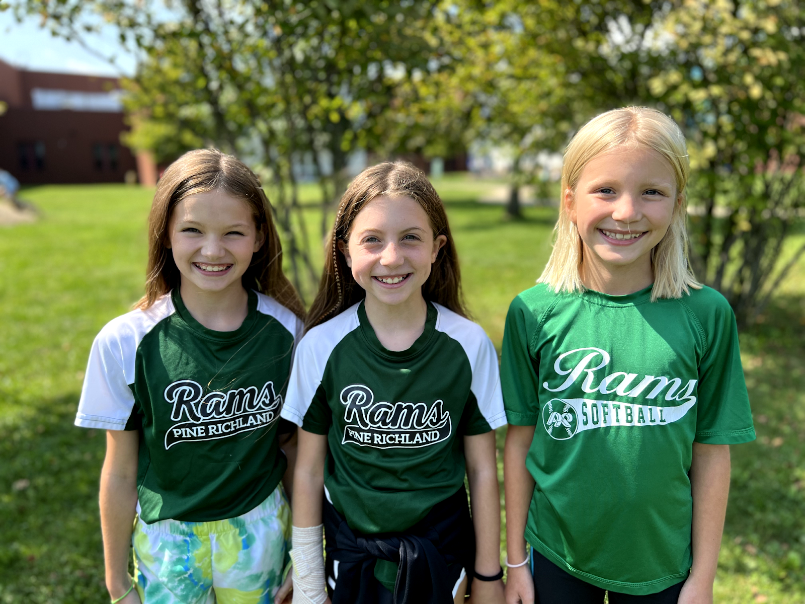 Three EHUE students smile for a photo