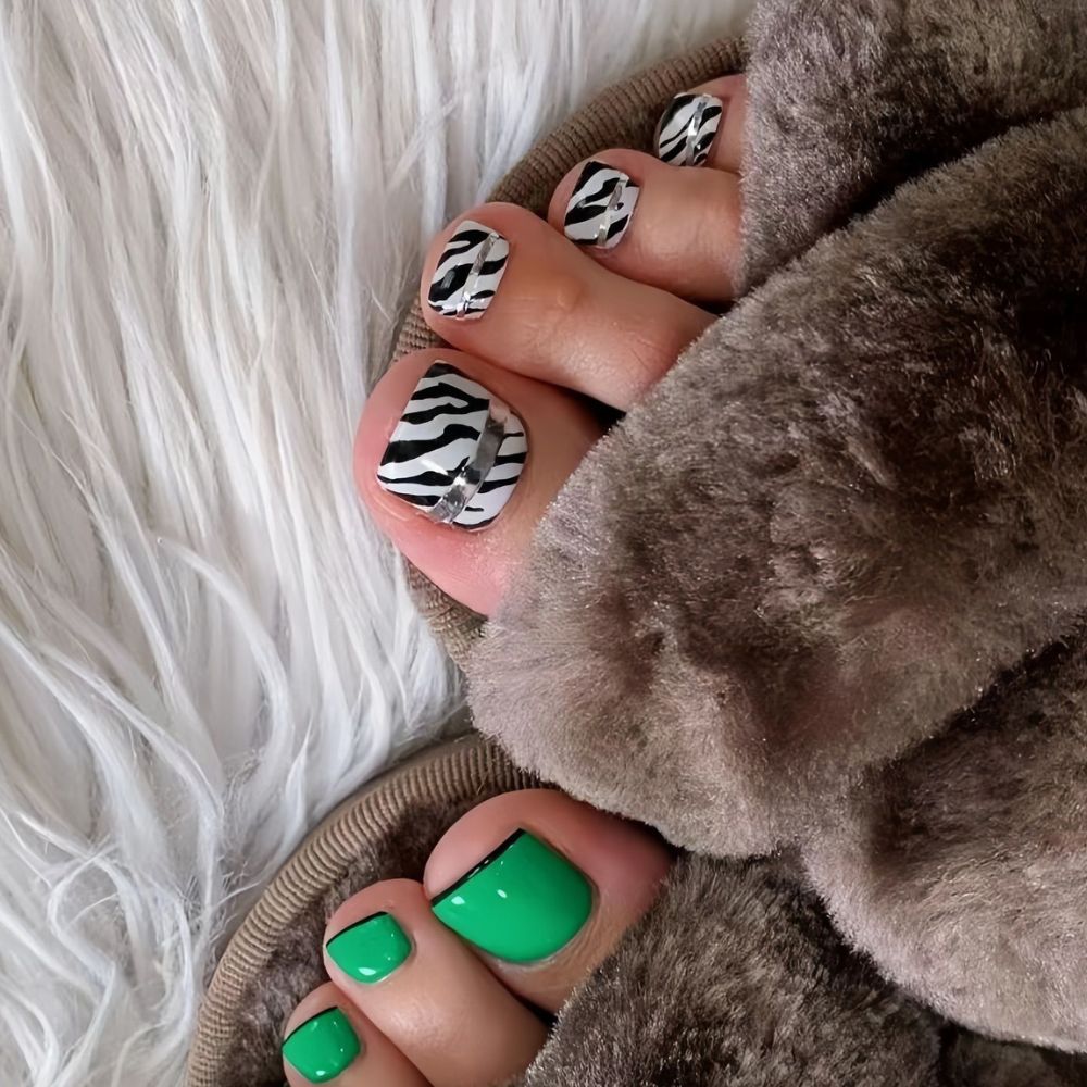 Close up of foot with radiant toe nail having Black and White Toe Nail Designs