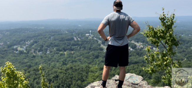 Testing out hiking boots at the top of a mountain