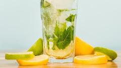 Slices Fruits Near Glass Drink With Ice Herbs