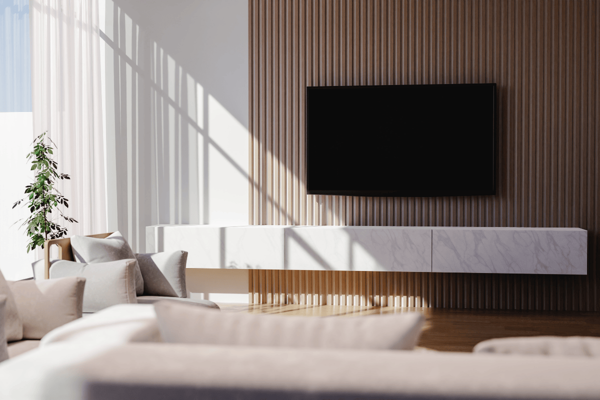 Fluted wall panel illuminated by natural light, with white couches and indoor plant adding freshness to the space.