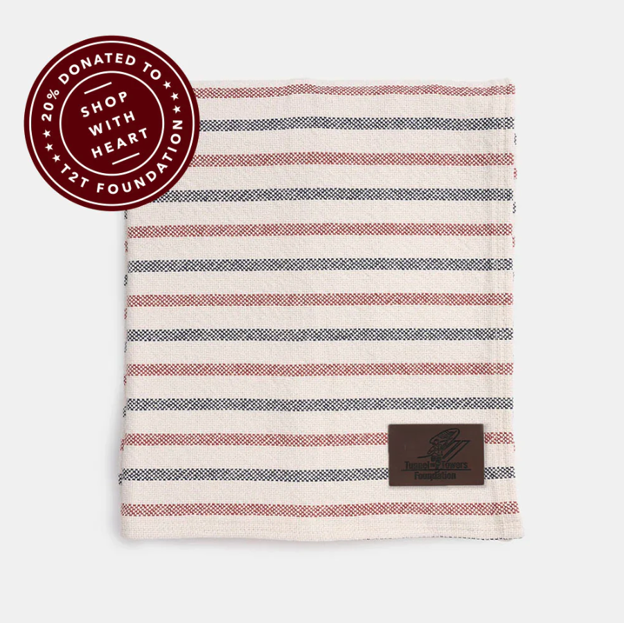 Featuring a patriotic red, white, and blue woven pattern and finished with a leather patch bearing the Tunnel to Towers logo