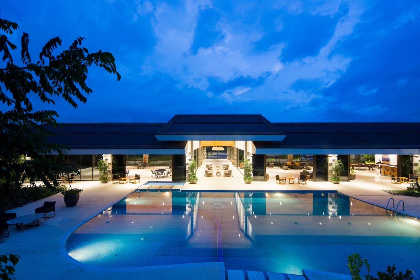 A luxurious resort suite overlooking the beach at night. 