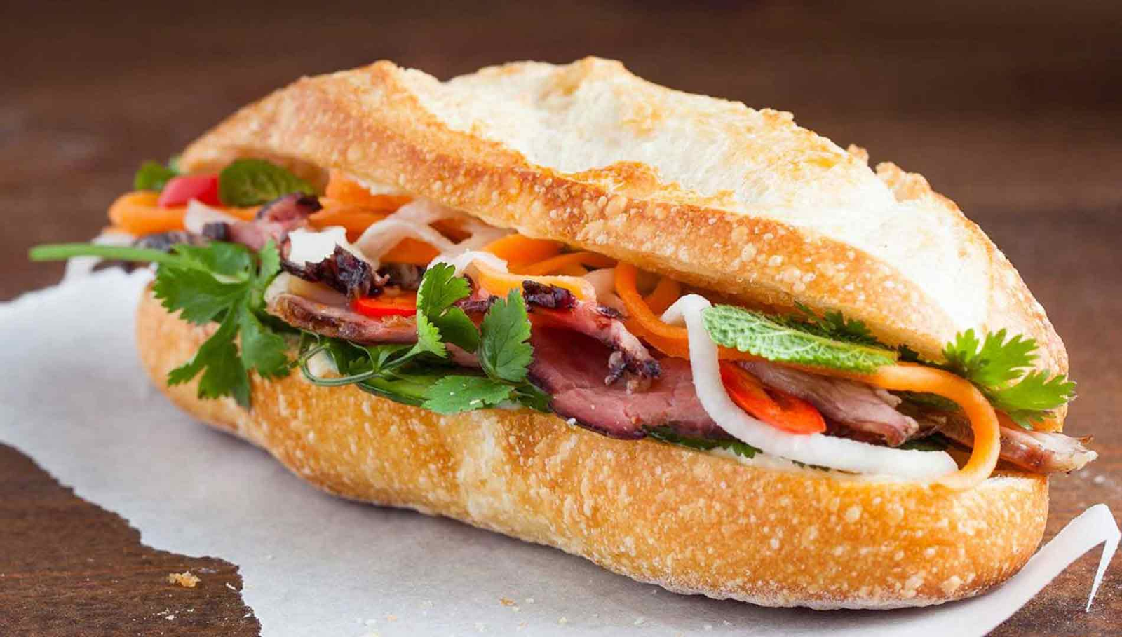 /SEO-images/2025 SEO/Traffic TA/MN/vietnamese-breakfast/vietnamese-breakfast/golden-crispy-banh-mi-sandwich-filled-with-colorful-pickled-vegetables-and-fresh-cilantro