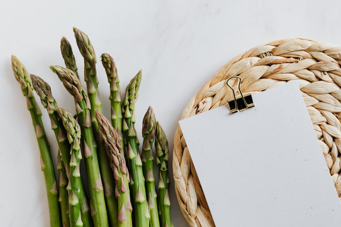 Photo by Photo By: Kaboompics.com: https://www.pexels.com/photo/asparagus-pods-with-paper-sheet-on-table-4032980/