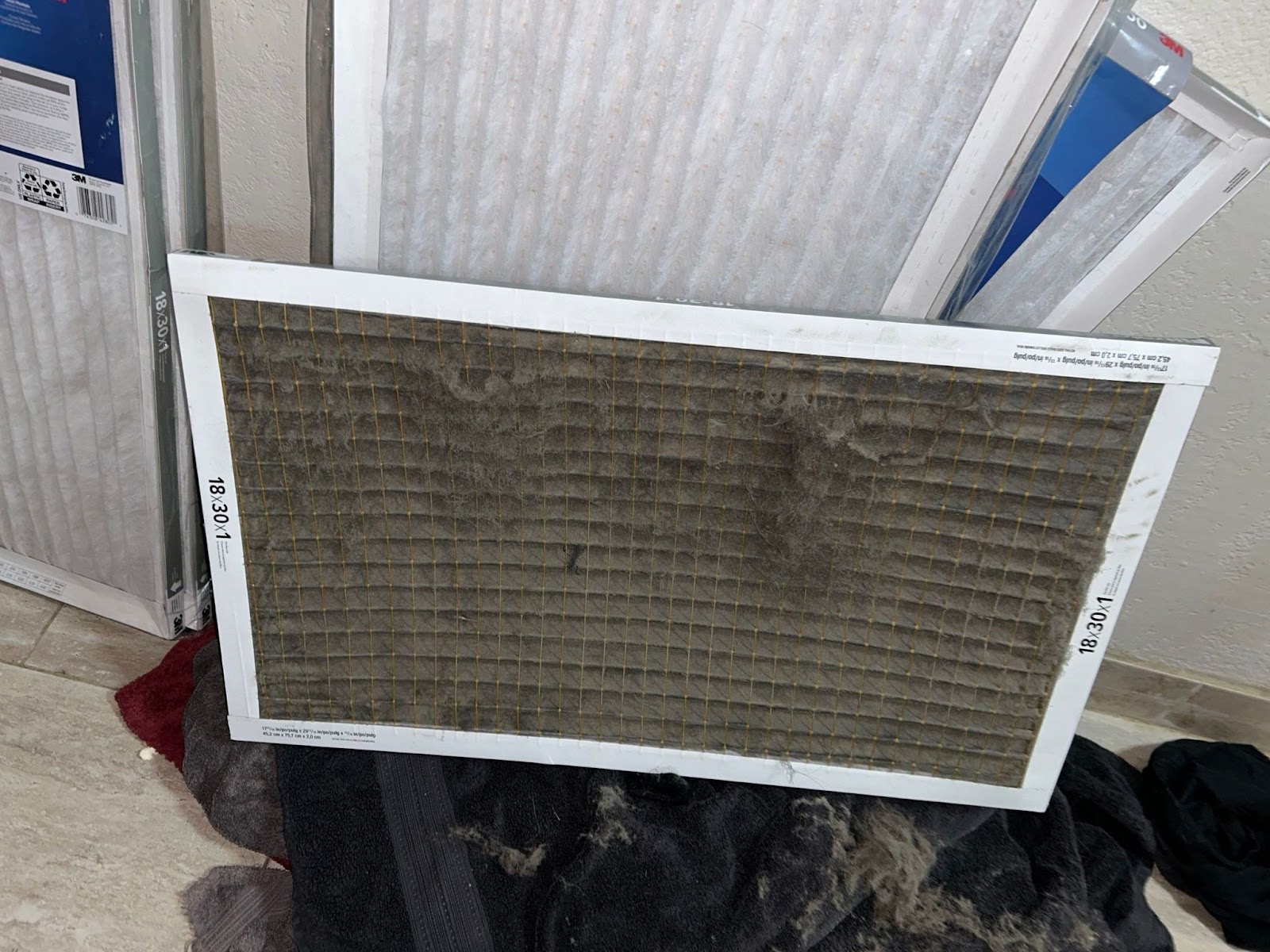 A dirty air filter covered in dust.