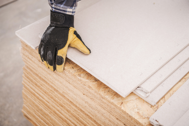 how tariffs will affect your home remodeling project remodeler picking up plywood board custom built michigan