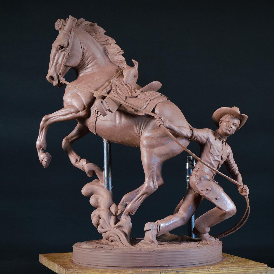 A statue of a person riding a horse

Description automatically generated