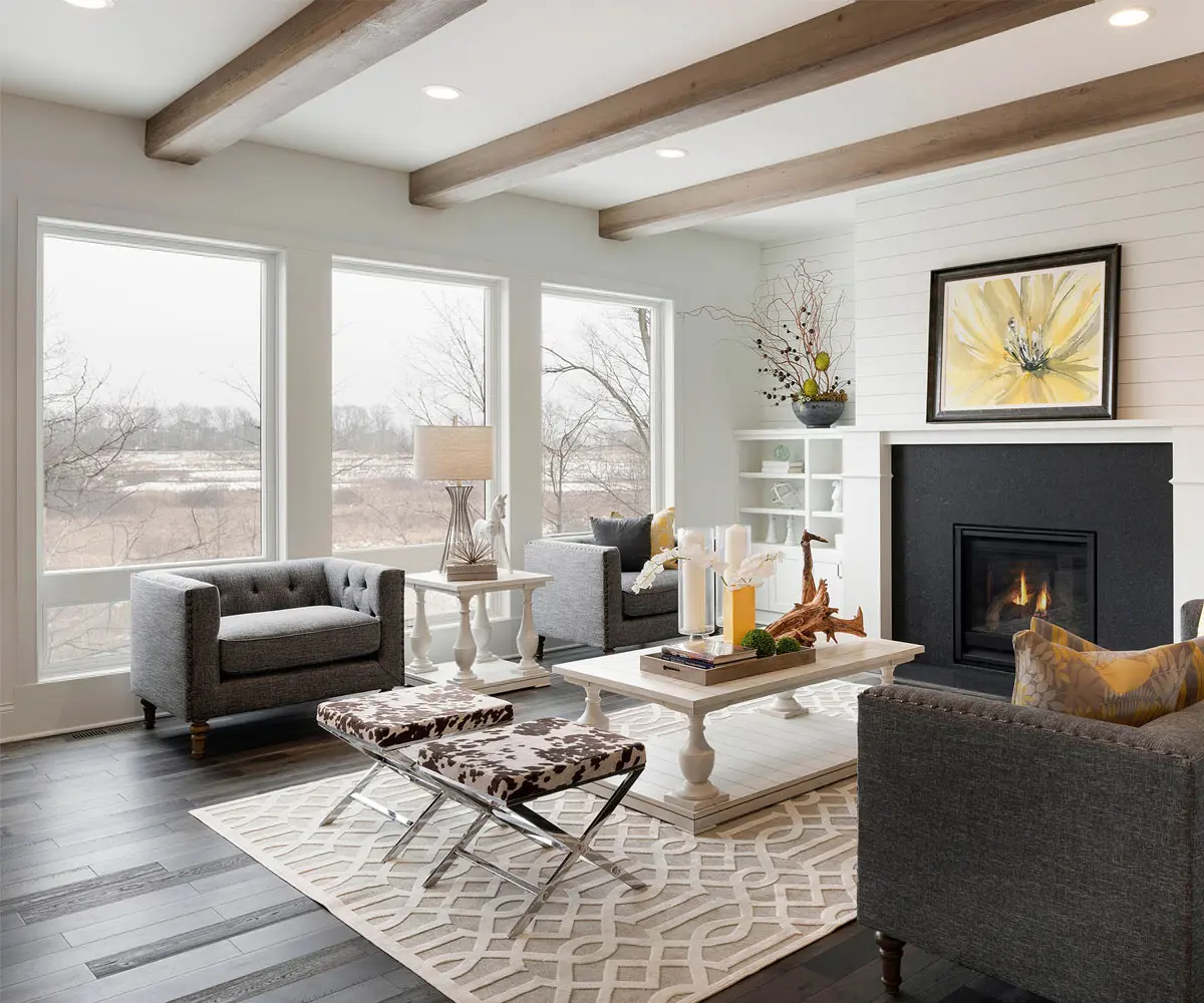 This image depicts a spacious living room featuring large windows. The sleek, energy-efficient windows create an open, airy feel while maintaining excellent insulation.