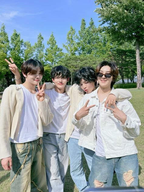 This is a group picture of 1VERSE members wearing a white t-shirt, milk colour jackets, and blue jeans 

