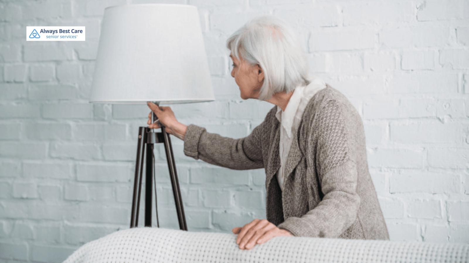 This image depicts a senior woman checking a lamp