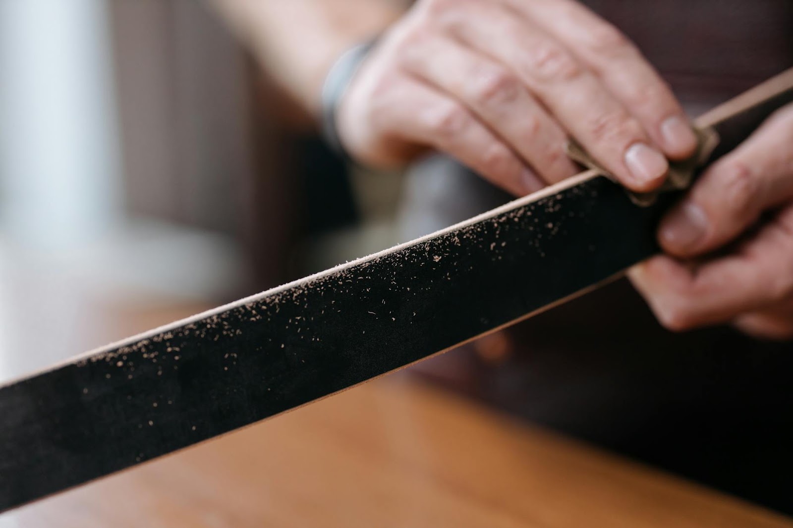 https://www.pexels.com/photo/a-person-polishing-a-wooden-slab-with-a-sand-paper-6654757/