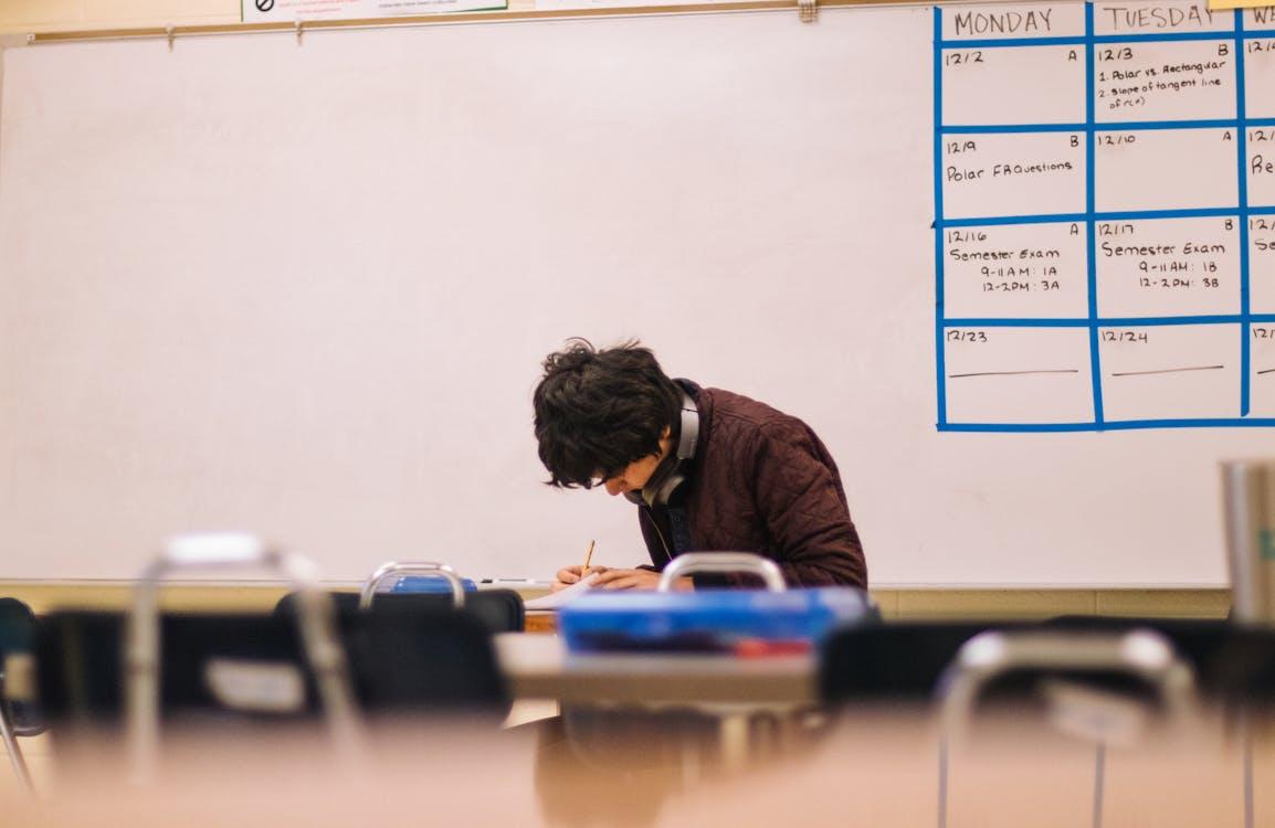 Free Man Writing on Table Stock Photo