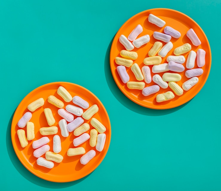 Top view of candy-like capsules on plates