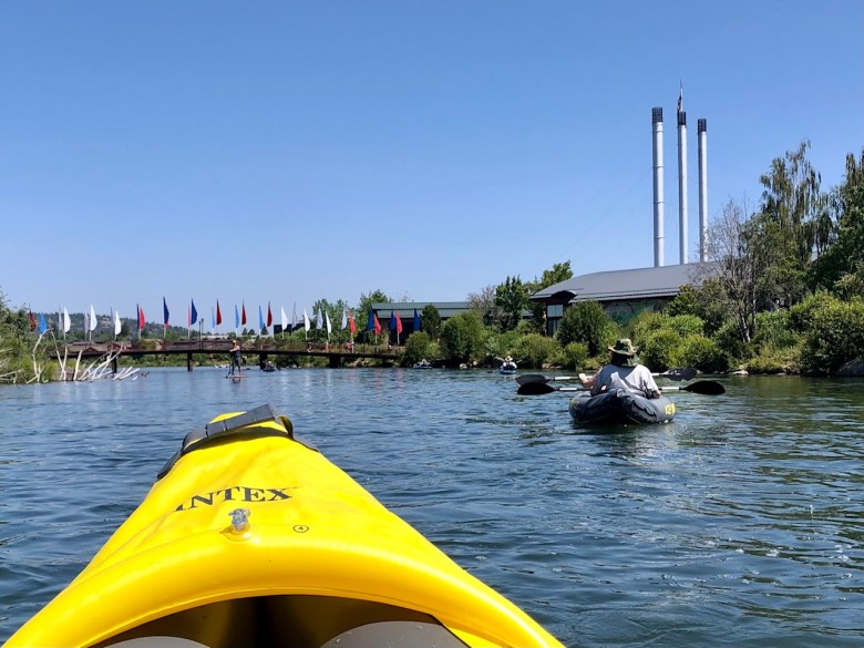 Floating down the Deschutes River past the Old Mill District shopping Center