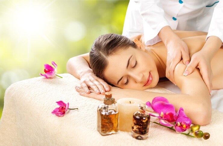 Beautiful young woman relaxing with hand massage at beauty spa