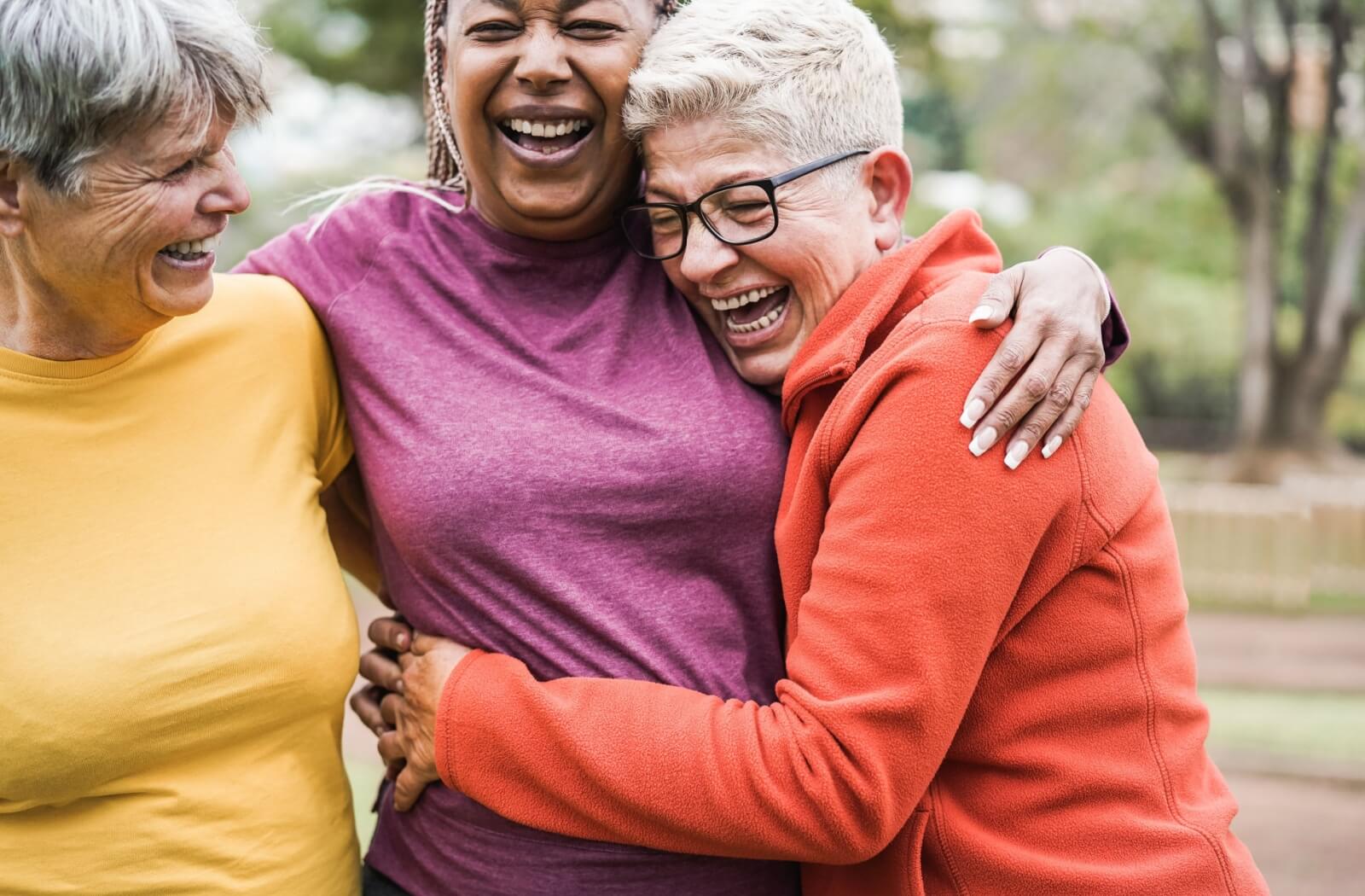 A group of older adult women laughing with each other