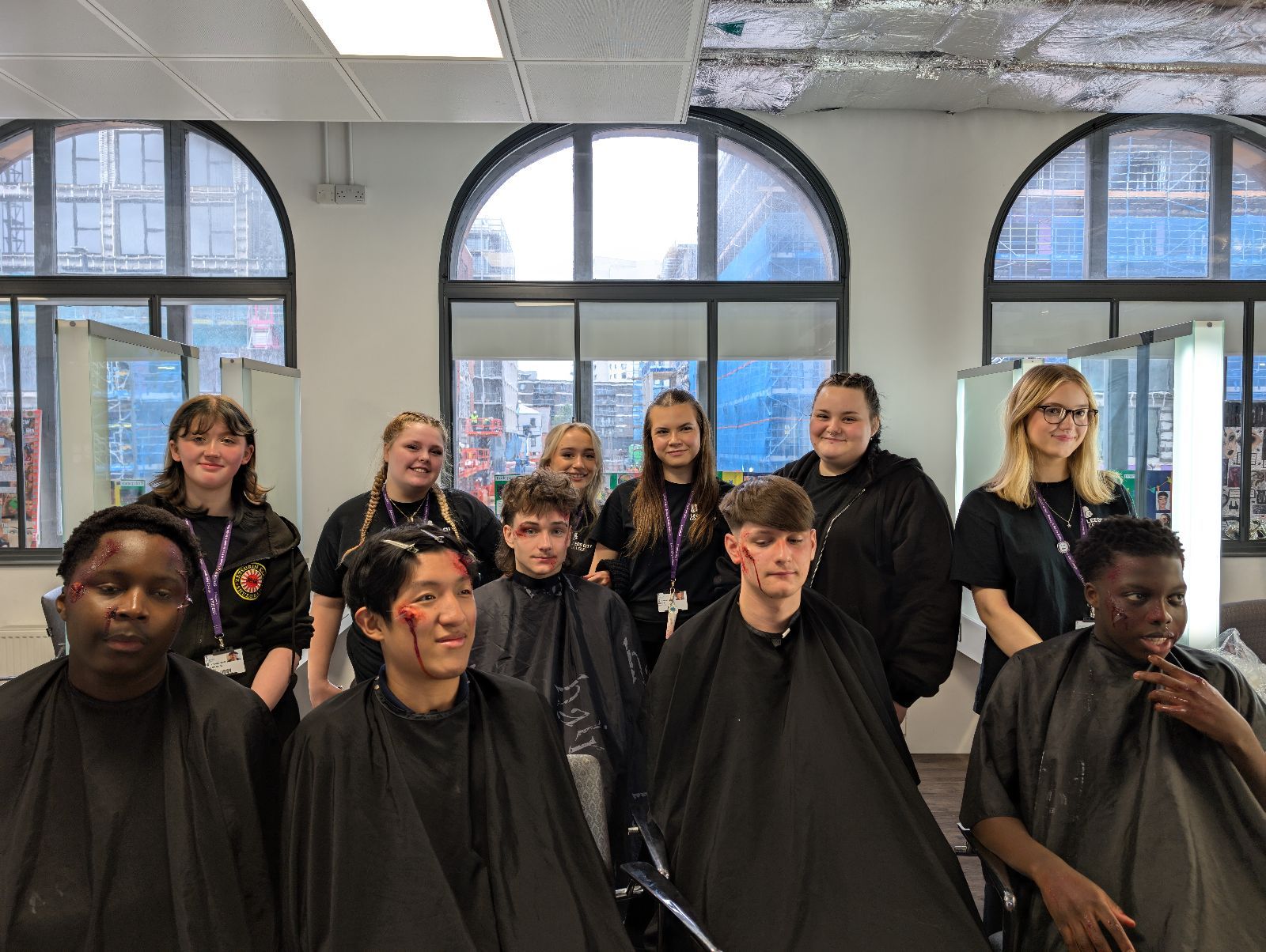 students in special effects makeup to recreate road traffic collision injuries sat in front of printworks media makeup students who did the makeup